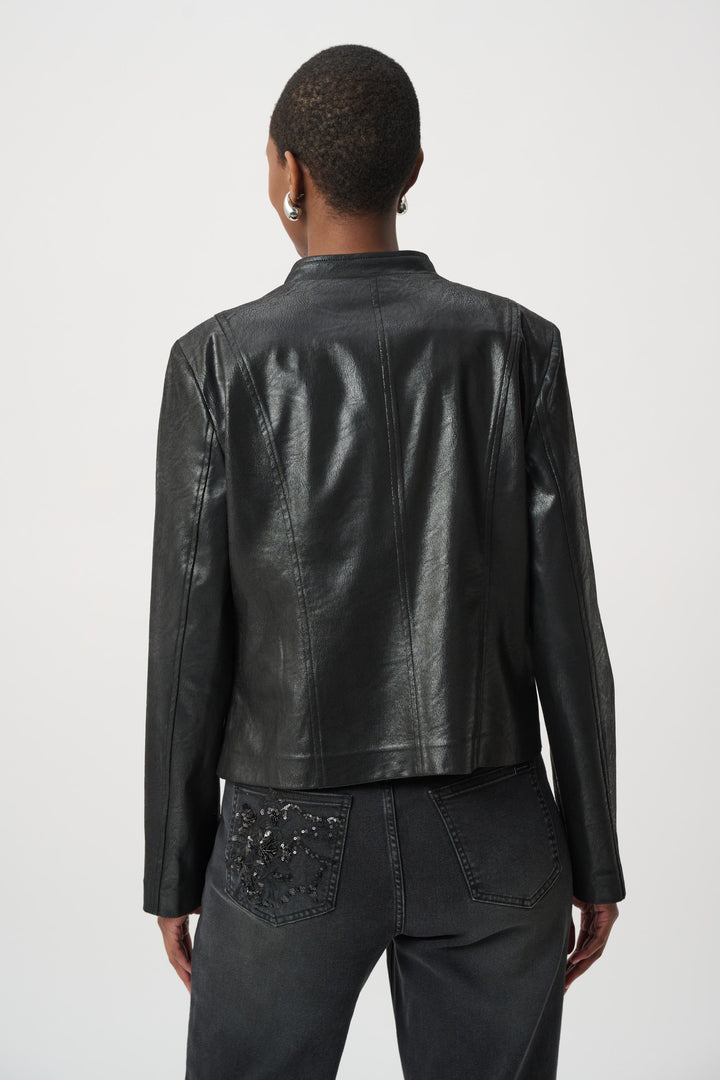 Woman shown from the back wearing a black leather jacket with floral embellishments on a white background