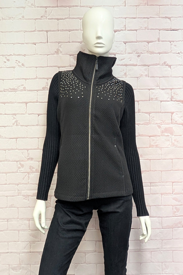 A mannequin wearing a black sleeveless vest with a high mock neck.