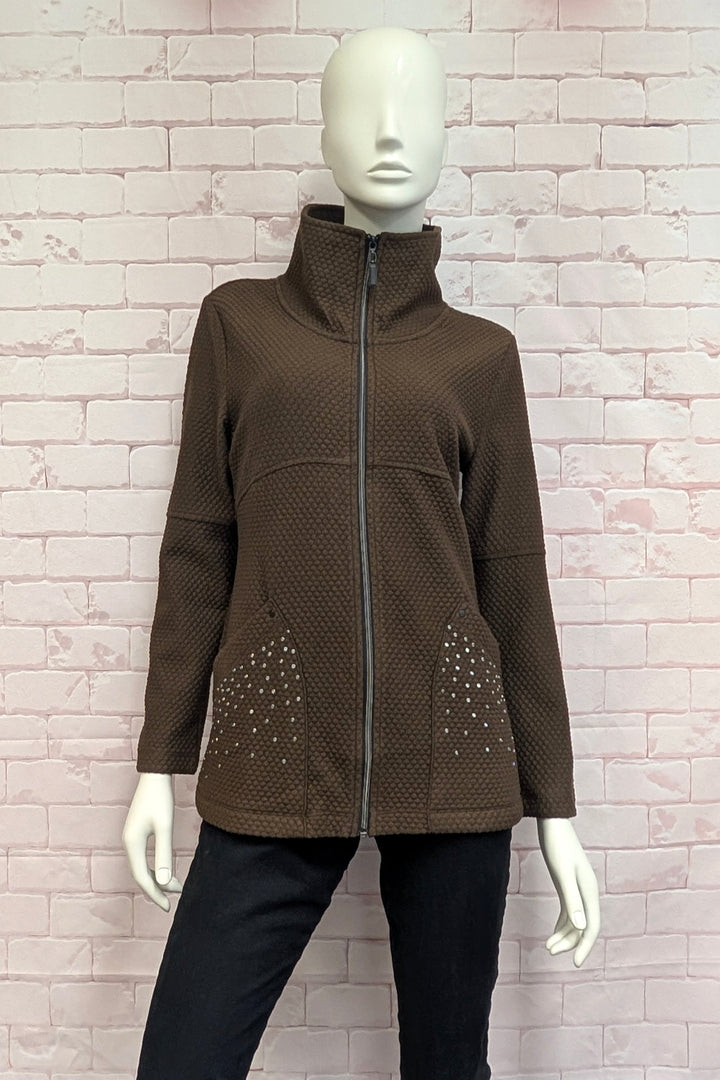 A mannequin wearing an off-white textured zip-up jacket with a high stand collar and decorative rhinestone patterns on the lower front