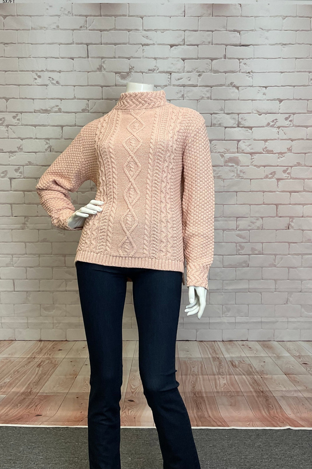 Cotton Country Fall 2024 Its funnel neckline and long sleeves are intricately designed with cable knit for added elegance and warmth. Expertly crafted, this sweater will bring style and comfort to your wardrobe.