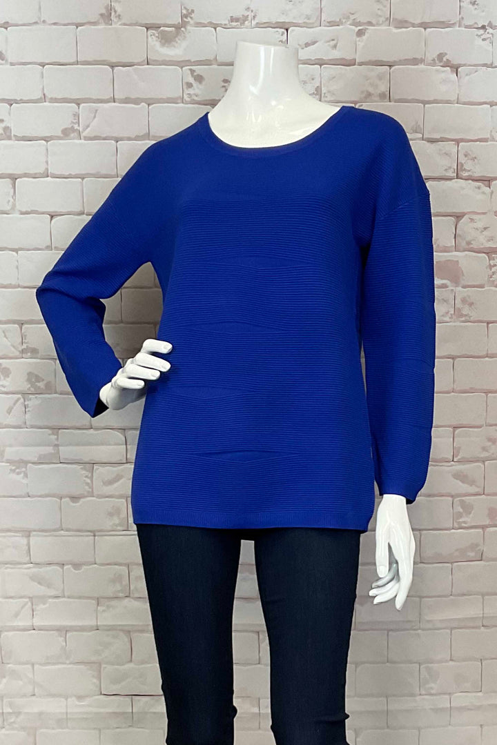 Variations Fall 2024 This Long Sleeve Ottoman Rib Top features long sleeves and a beautifully textured ribbed knit design. Made with stretch fabric, it pairs perfectly with slim leg pants or jeans for a comfortable and stylish look.