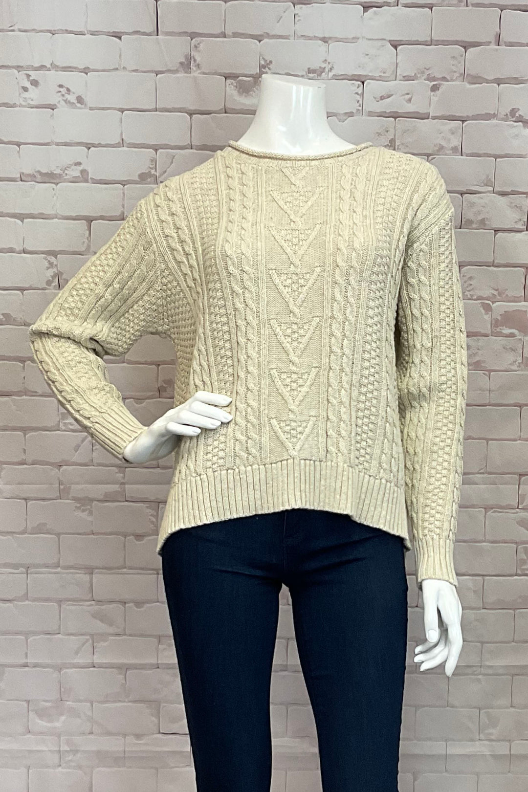 Cotton Country Fall 2024 a light and soft cable knit sweater with drop shoulders, contrast rolled collar, and eco-friendly fabrics. With a contrast hem, wear it multiple ways for versatility.