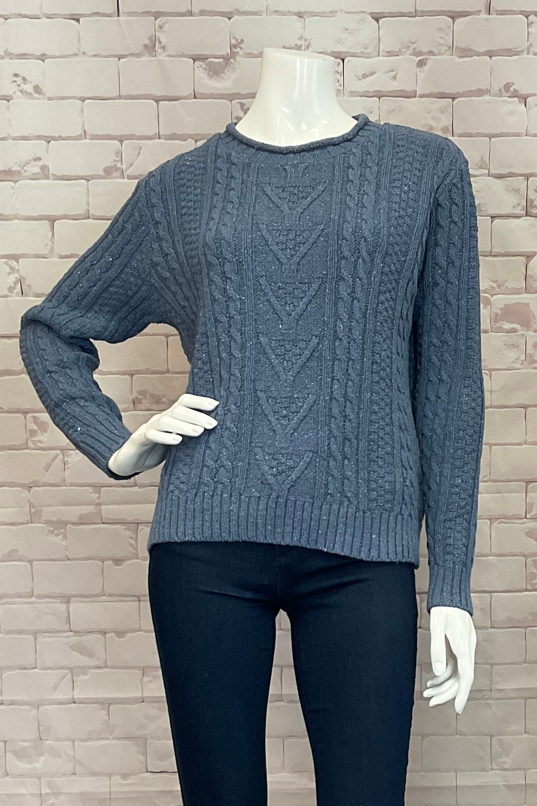 Cotton Country Fall 2024 a light and soft cable knit sweater with drop shoulders, contrast rolled collar, and eco-friendly fabrics. With a contrast hem, wear it multiple ways for versatility.