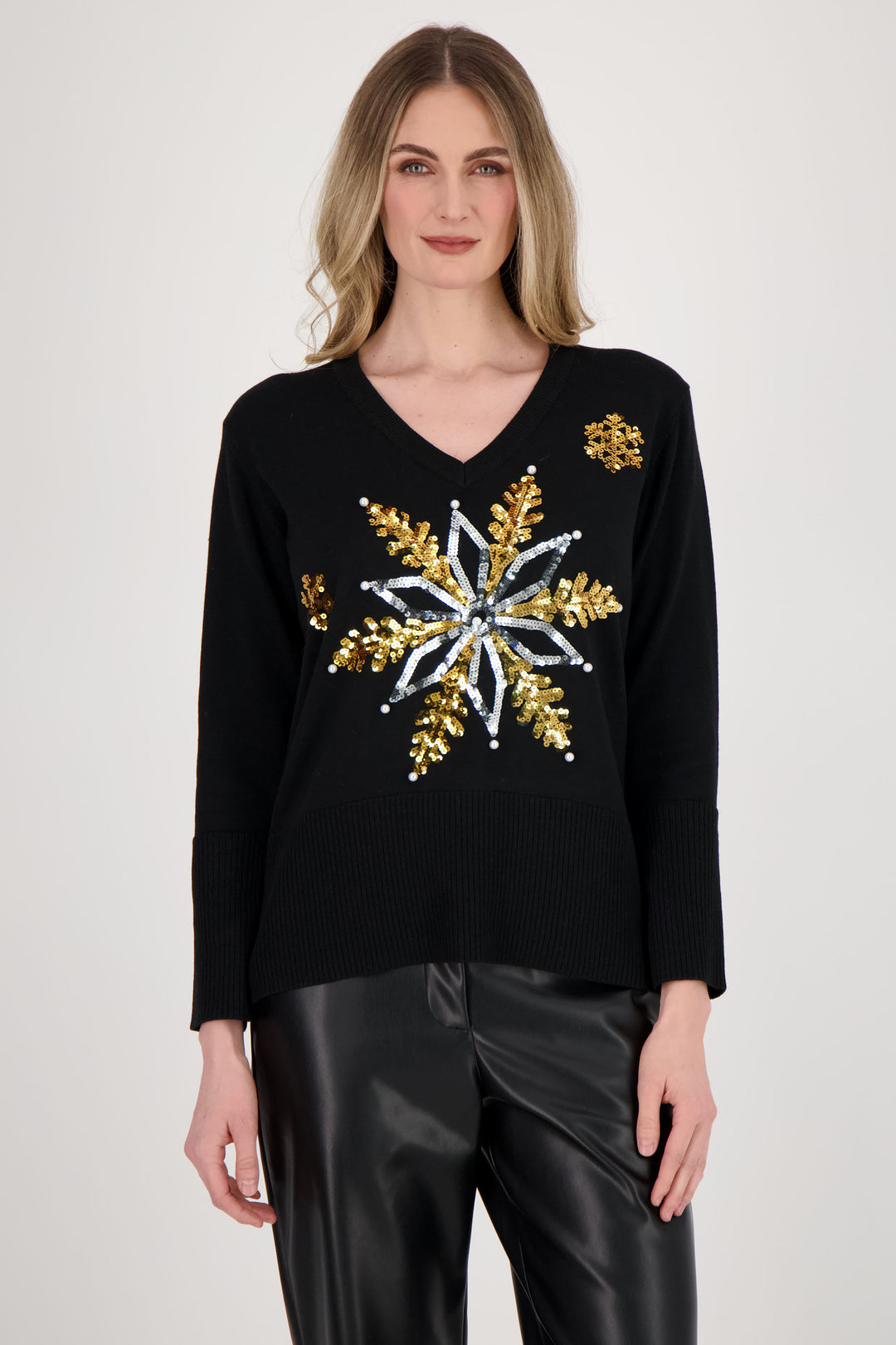 Spanner Fall 2024  This super soft sweater features a gorgeous star snowflake design, complete with bling pearls for added flair! The ribbed hem and cuffs add a classic touch, while the sharp contrast v-neck adds a unique twist. 