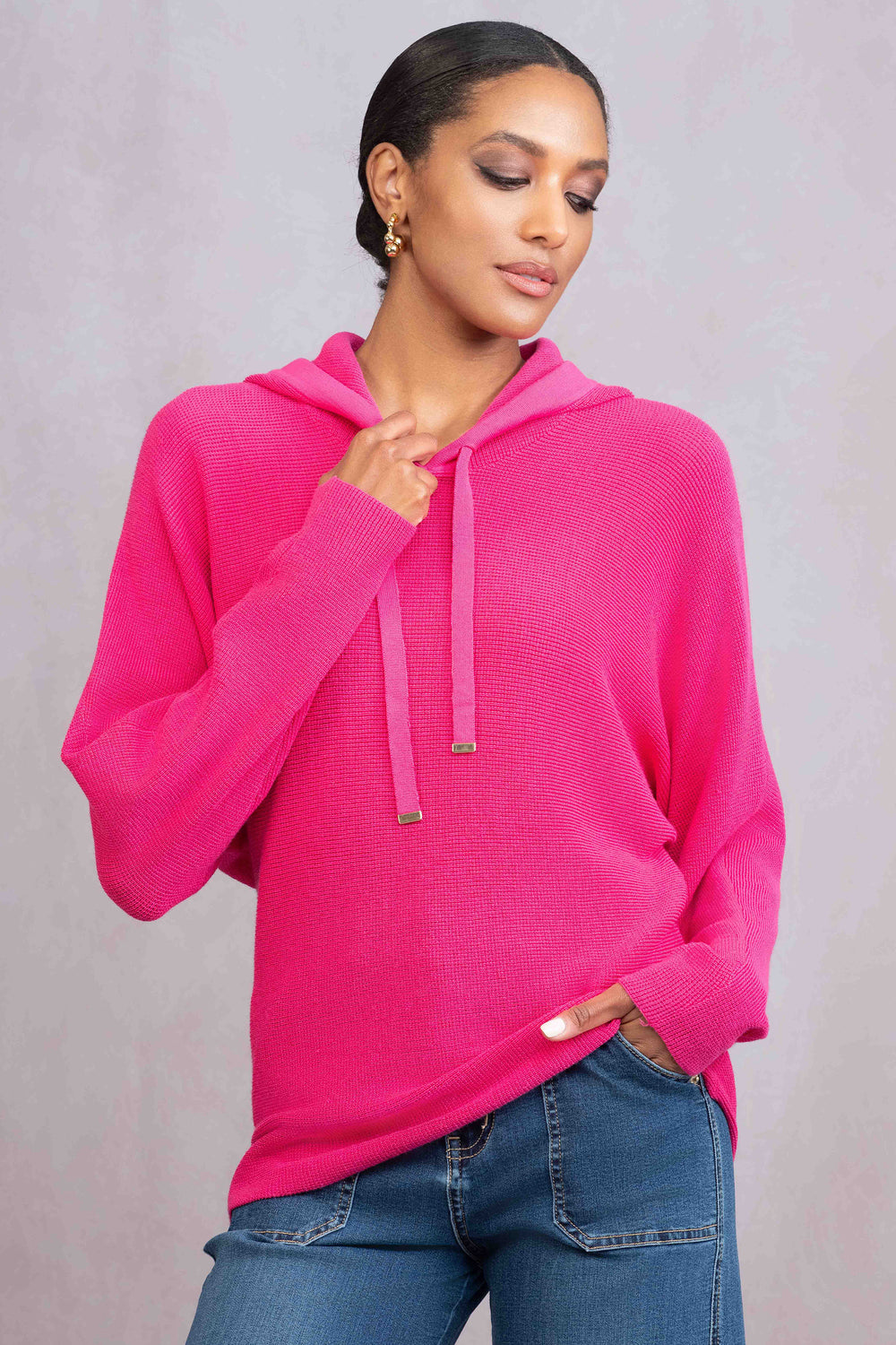 ALISON SHERI Fall 2025 
This knit hoodie top features a hood with a drawstring and a looser fit, combining polished style with relaxed comfort.