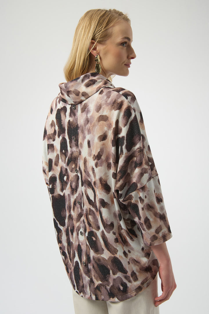 Joseph Ribkoff Fall 2025 
The latest design includes subtle sparkles woven throughout, adding a touch of shimmer to the bold animal print. A stylish cowl neck enhances its chic appeal, while the button-back detail offers a unique finishing touch. Perfect for effortless style with a hint of glamour.
