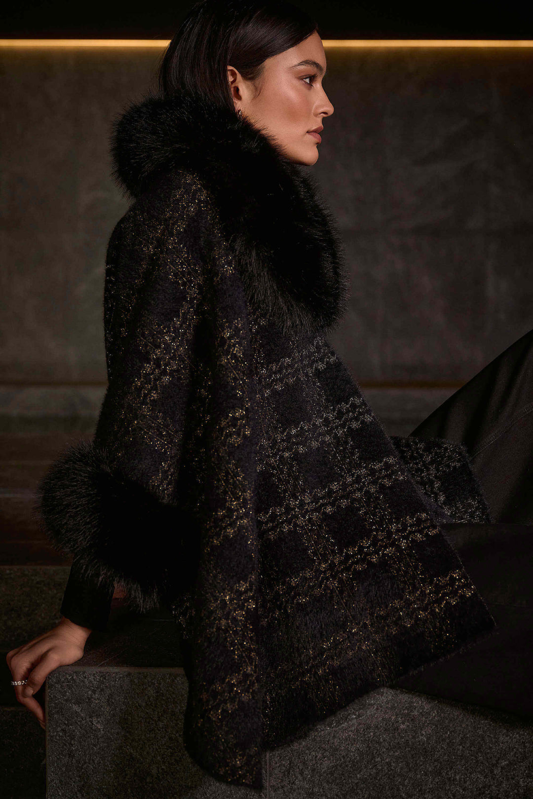 Joseph Ribkoff Fall 2025 
Show off the distinct faux fur cape style poncho, with faux fur contouring the neckline and make a statement this Fall season!