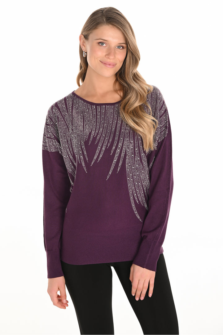 Frank Lyman Fall 2025 
This plum dolman top features a neat purple hue crafted from super soft, stretchy fabric for effortless comfort. The rhinestone floral pattern on the front adds refined sparkle, perfect for elevating your casual look.