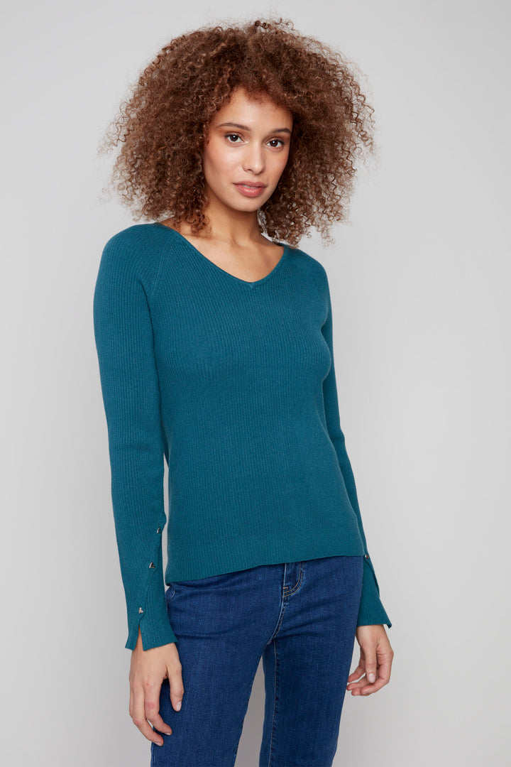 Charlie B Fall 2025 
This ultra-soft ribbed V-neck top combines cozy comfort with subtle detailing, featuring diagonal heart-shaped rivets on the sleeves for a distinctive touch. Its lightweight design makes it an ideal go-to piece for the early Fall season, offering both warmth and style. 