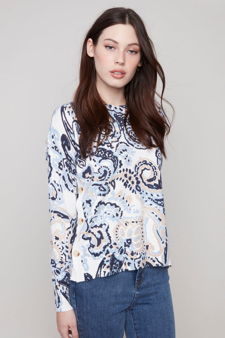 Charlie B Fall 2025 
This Paisley Long Sleeve Top With Side Buttons is made from plush knit fabric, giving you a comfortable and stylish look. With a round neck, full length ribbed sleeves and side buttons, it's perfect for any casual occasion. 