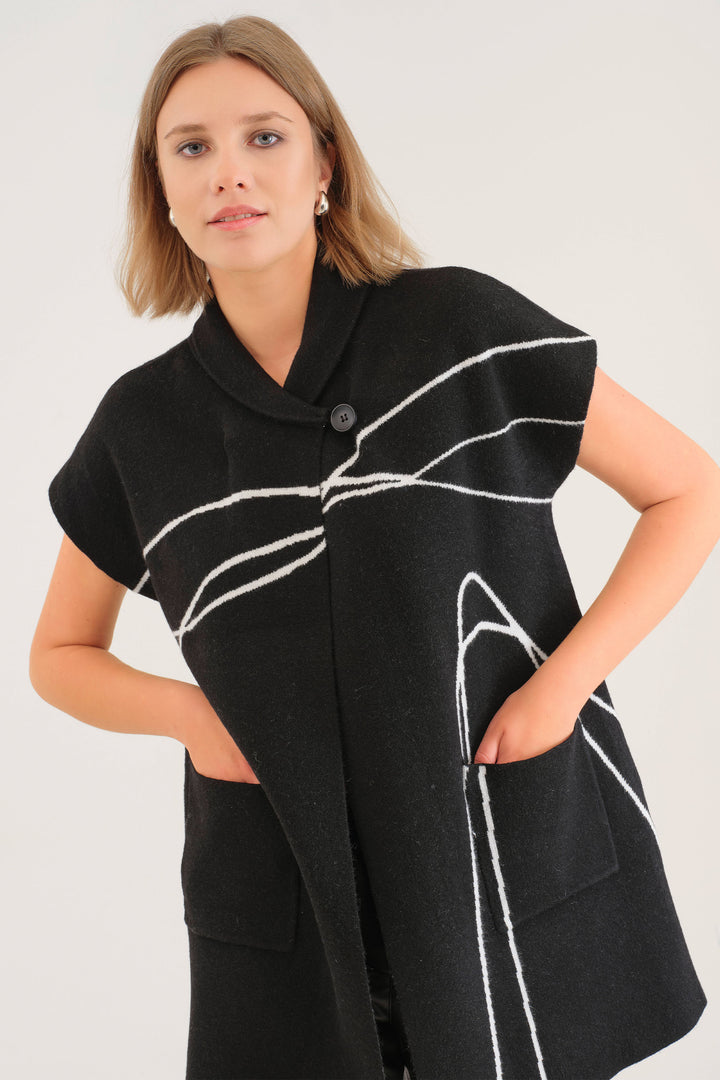 Dolcezza Fall 2025 
Elevate your layering game with this stylish sweater coat featuring an abstract lines pattern for a modern touch. Its short sleeves and open front design with a single button closure offer effortless versatility, while the folded shawl collar adds cozy sophistication.