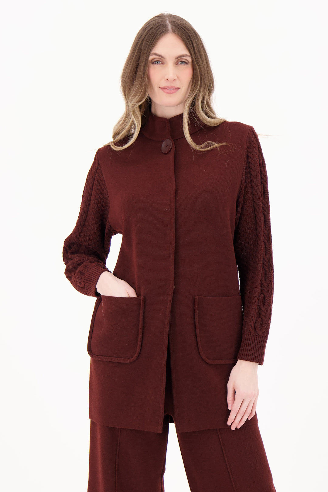 SPANNER Fall 2025 
This versatile coatigan combines cozy braided cable knit sleeves with snap buttons for easy styling. Featuring front pockets and a relaxed fit, you can wear it as a warm sweater top or as an outer layer coat, adapting seamlessly to your look and the weather.