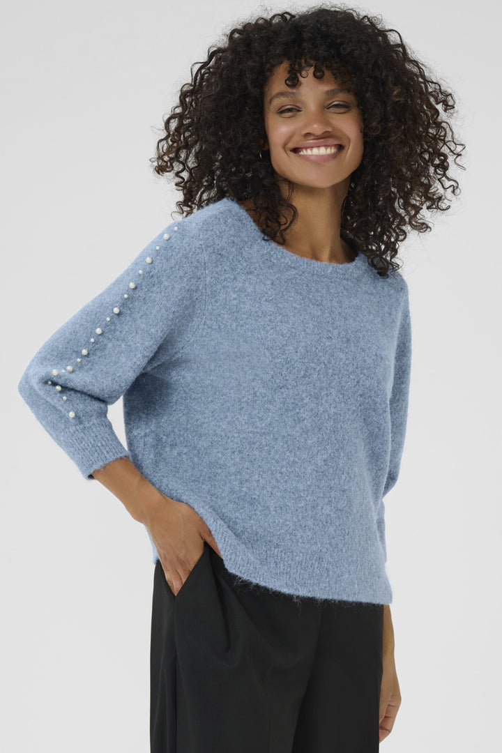 Kaffe Fall 2025 This elegant sweater top blends sophistication with comfort, featuring delicate pearl embellishments along the 3/4 length sleeves.