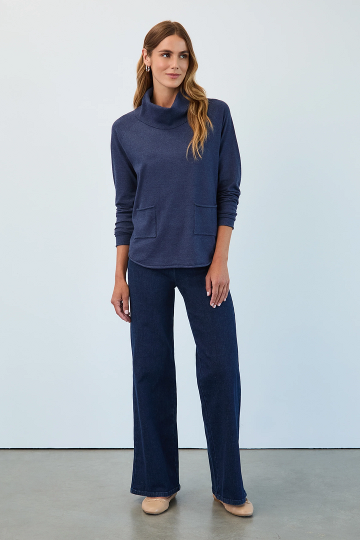 Woman wearing a navy blue outfit against a light gray background