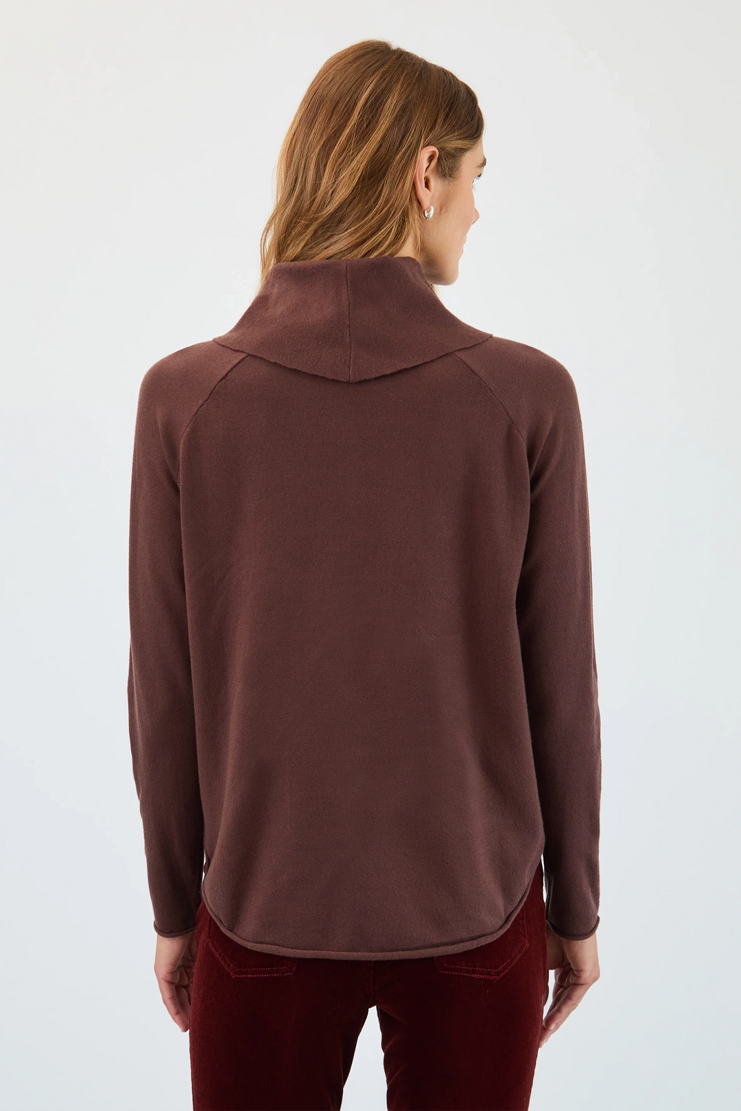 Person wearing a brown long-sleeve shirt with a collar on a white background