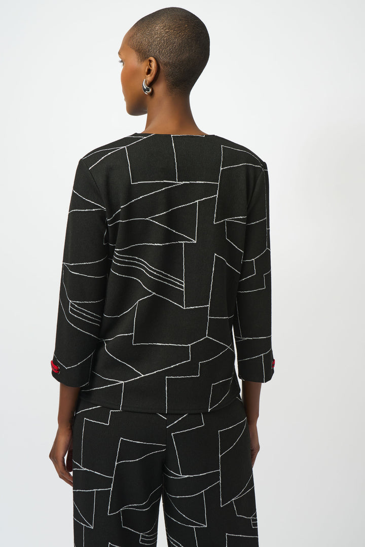 Person wearing a black geometric patterned outfit on a white background