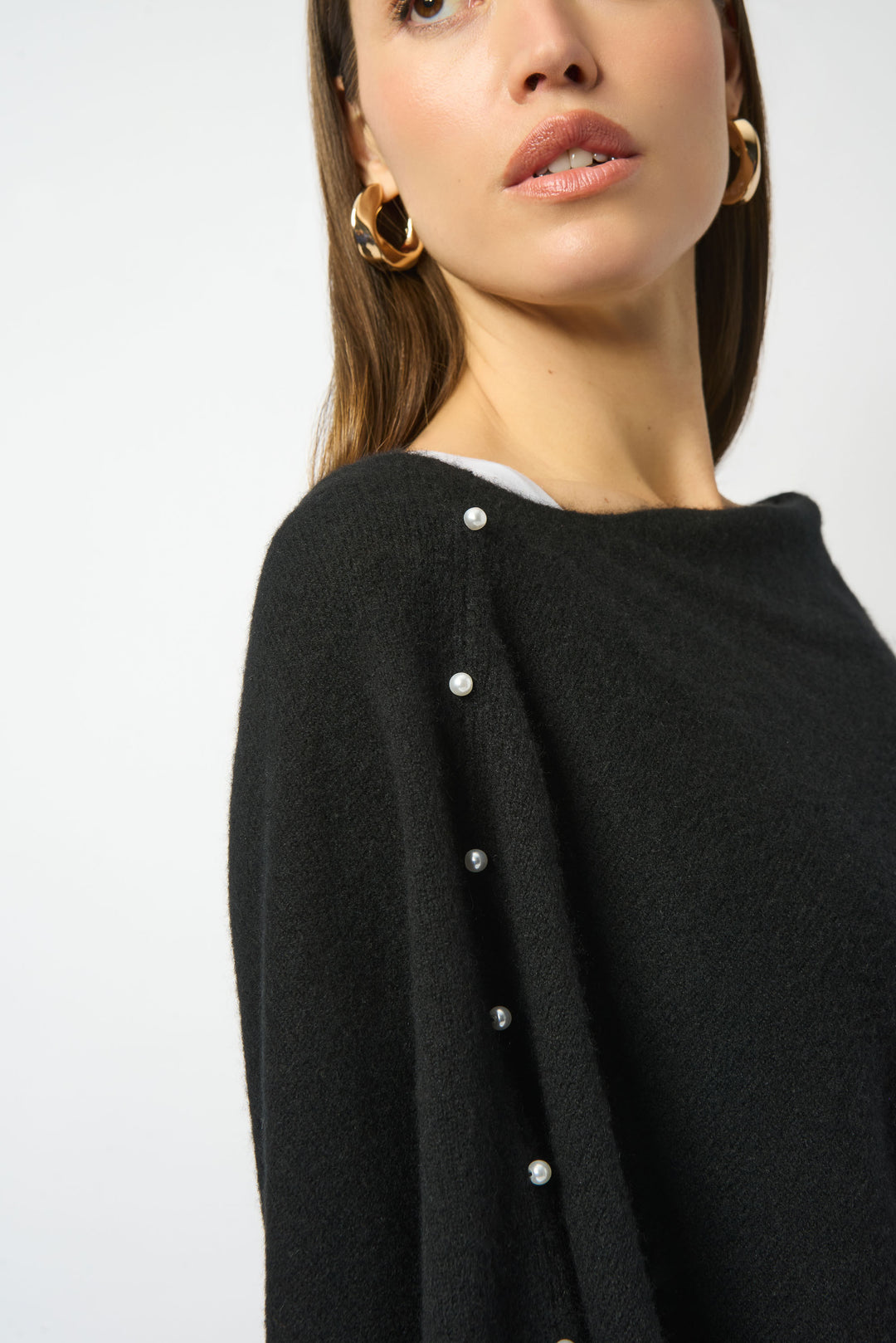 Black garment with pearl buttons on a white background