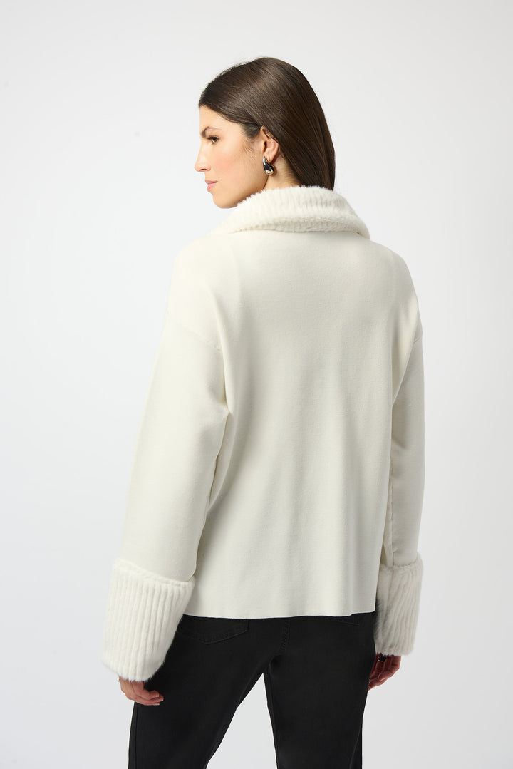 Woman wearing a cream-colored sweater on a white background