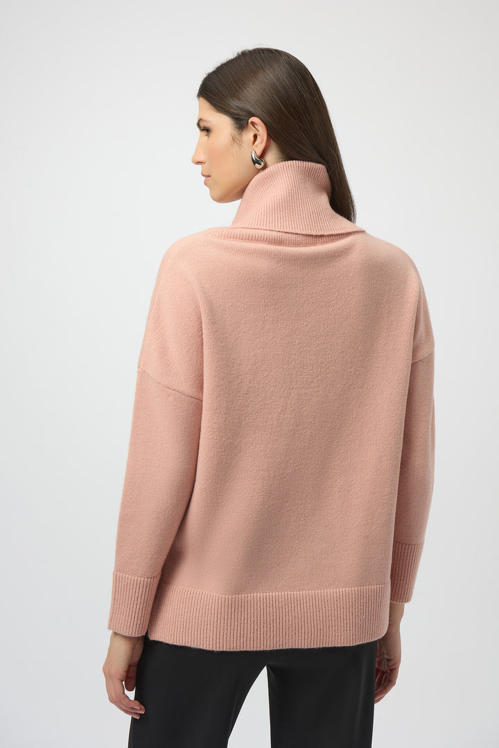 Woman wearing a pink sweater on a white background