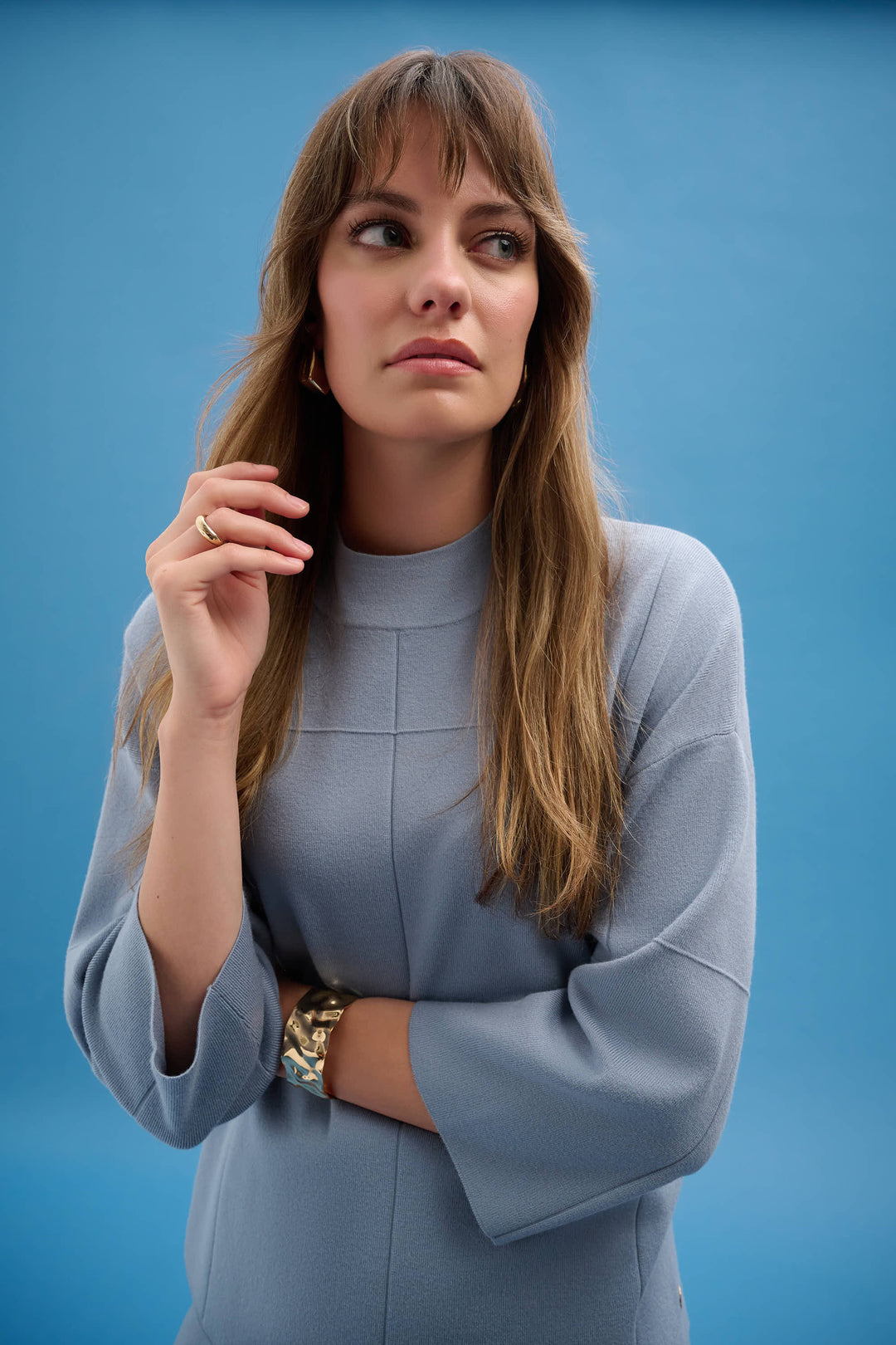 JOSEPH RIBKOFF Spring 2026 
This modern mock neck top features a chic windowpane pattern and a boxy, straight cut that offers effortless elegance. Crafted from a comfortable nylon and viscose blend, it is unlined for a lightweight feel. 