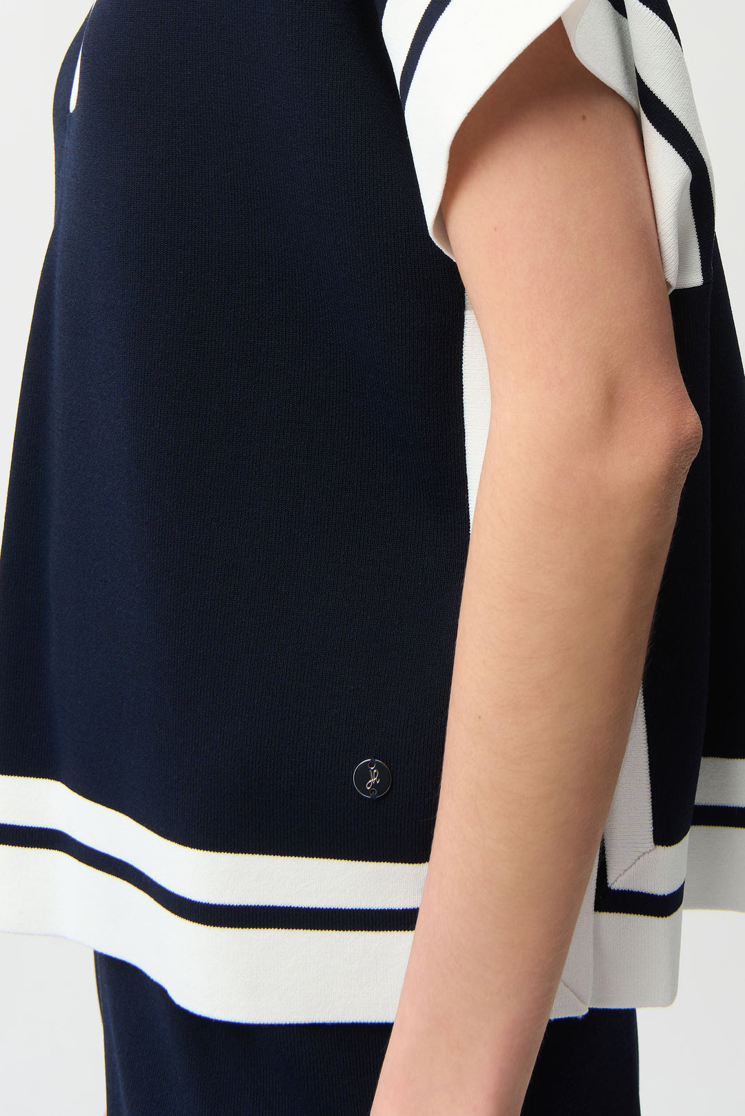 Navy sleeveless top with white stripes on a white background