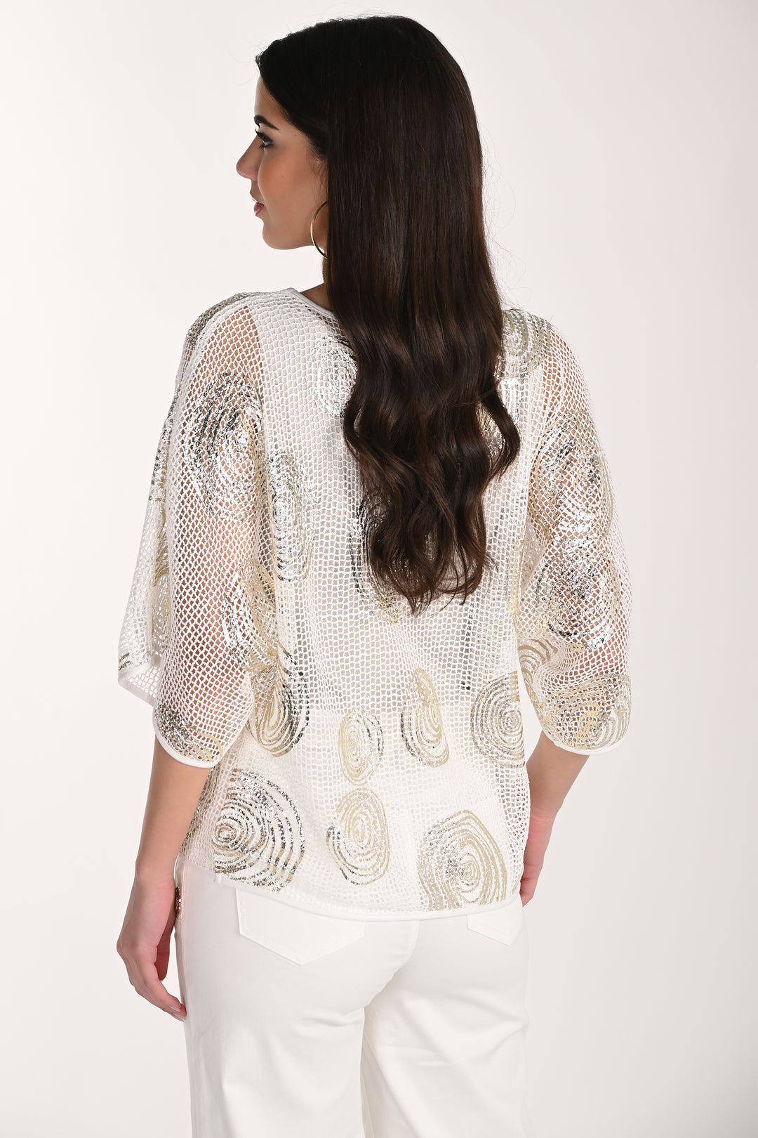 Woman wearing a white pullover top with a plain background