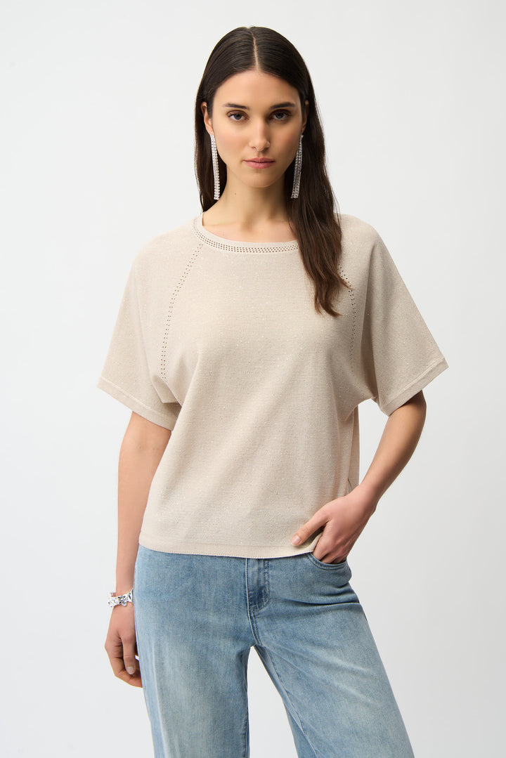 Woman wearing a beige sweater and blue jeans on a white background