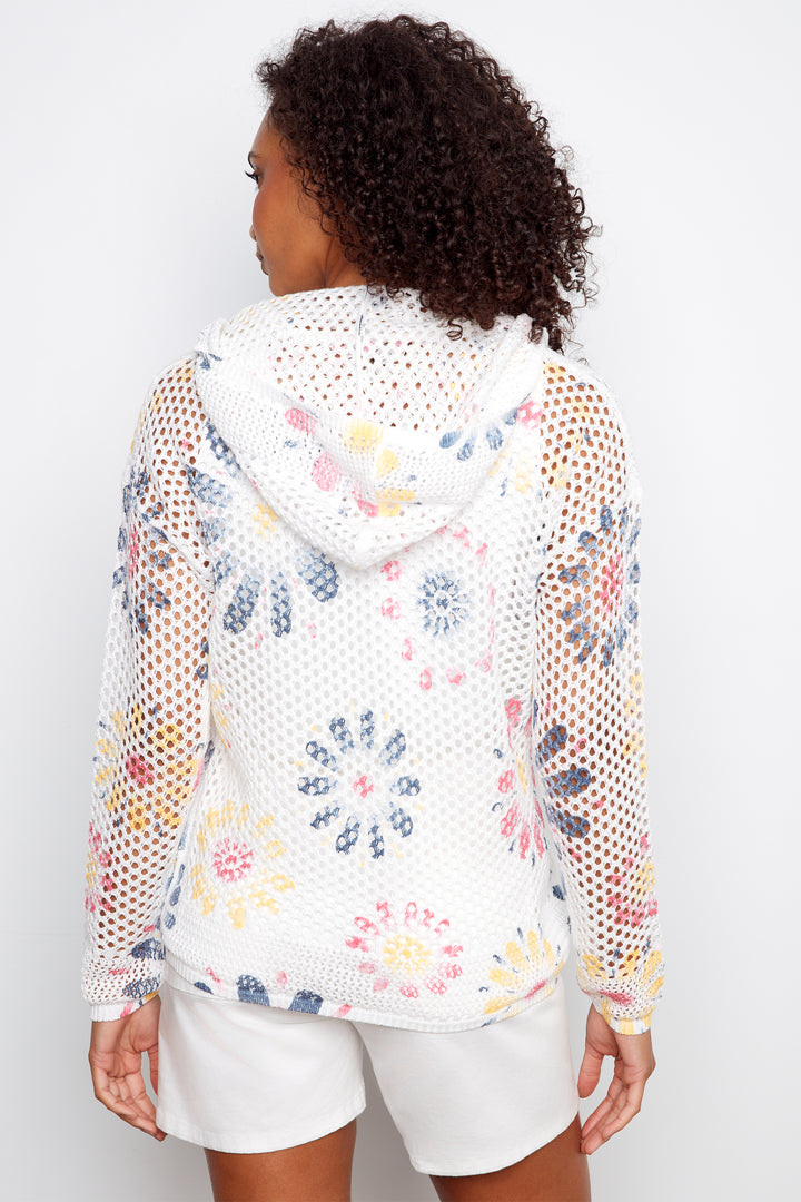 Woman wearing a floral mesh hoodie with a white background
