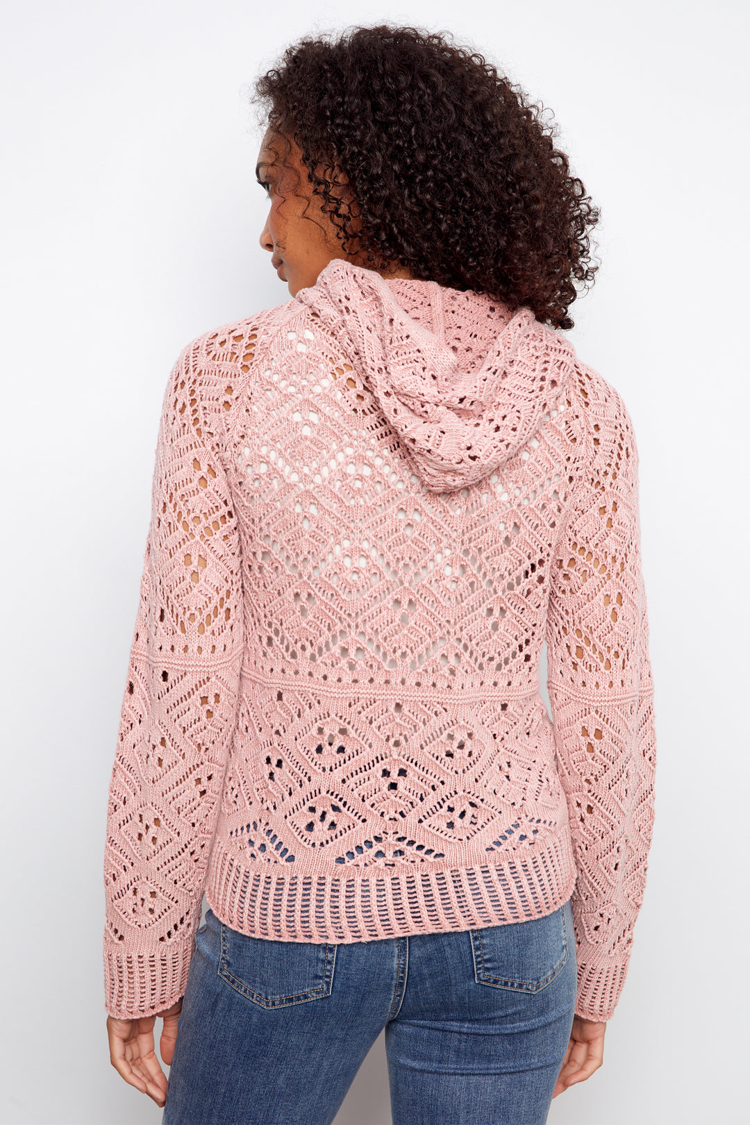 Person wearing a pink lace hoodie against a white background