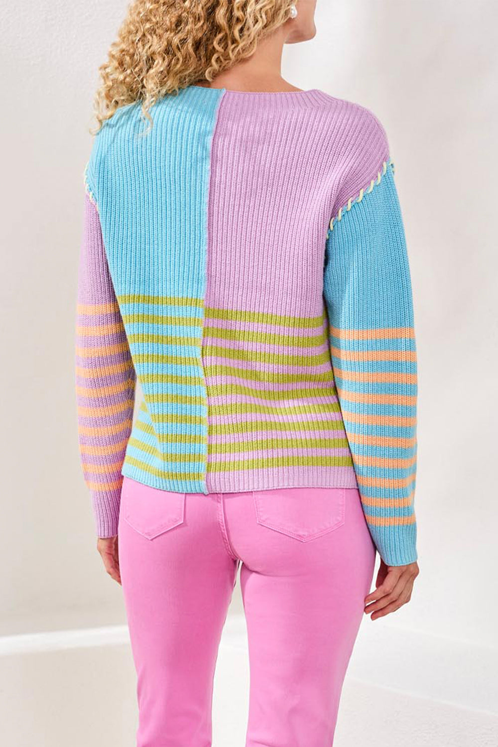 Pastel striped sweater with a plain background