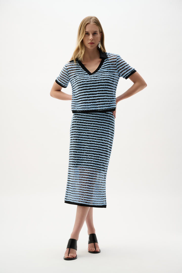 Woman wearing a black and blue striped set on a white background