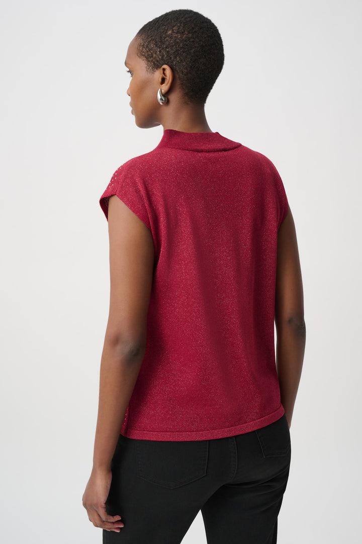 Woman shown from the back wearing a red sleeveless top with rhinestones and black pants on a white background