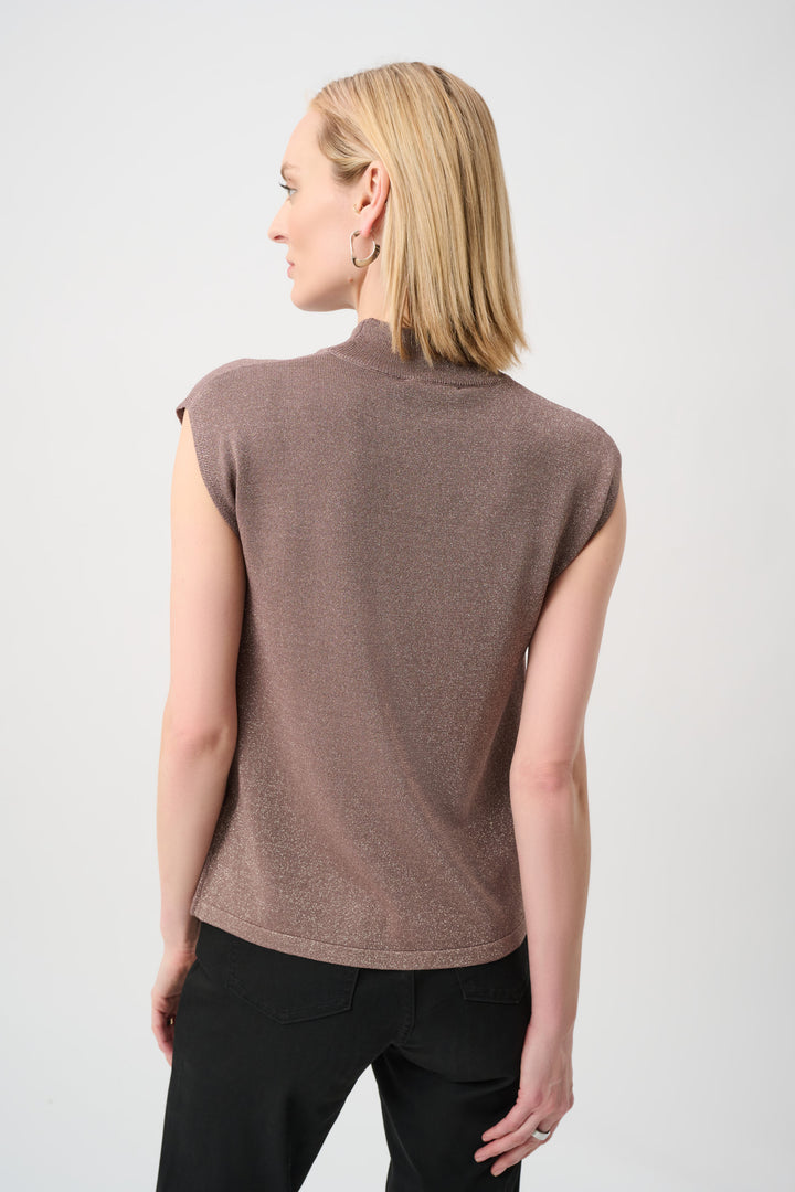 Woman wearing a brown sleeveless top against a white background
