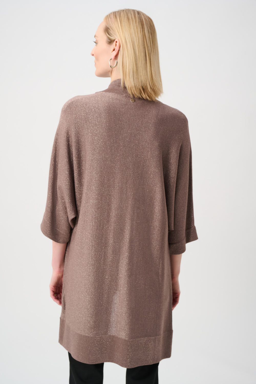 Woman wearing a brown cardigan on a white background