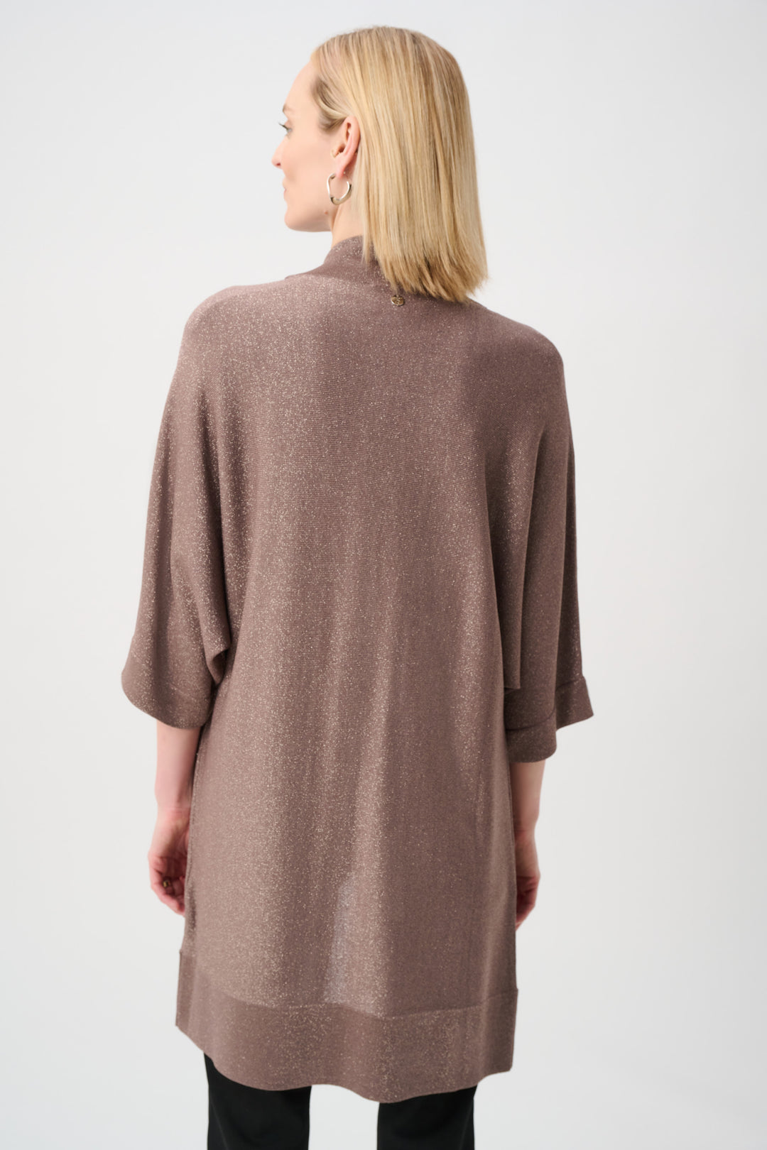Woman wearing a brown cardigan on a white background