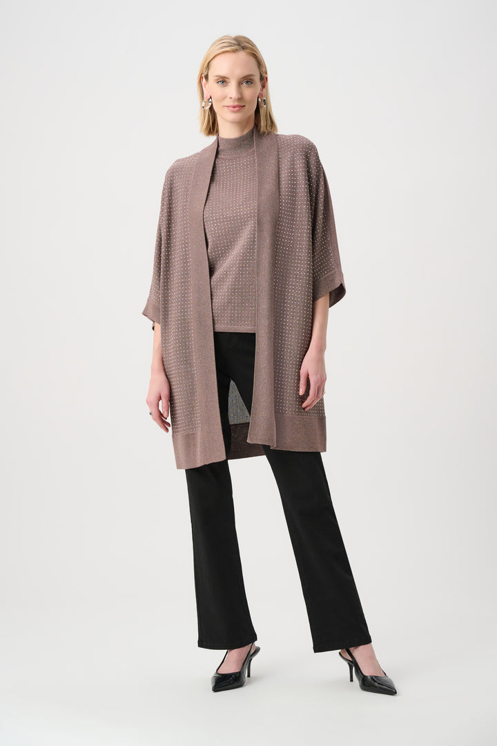 Woman wearing a brown textured coat over a black outfit on a white background