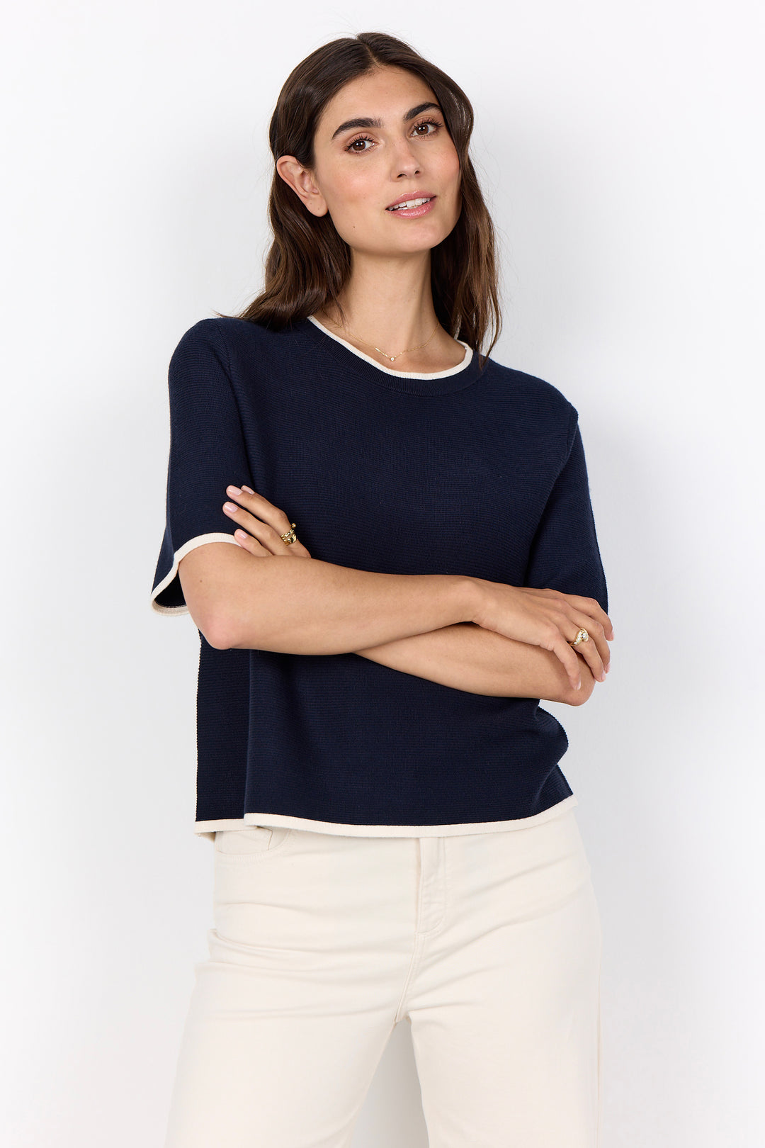 woman wearing a casual ribbed t-shirt sweater on a white background.