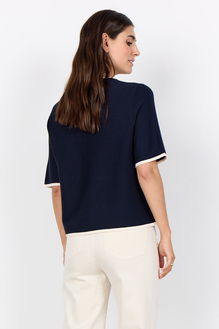 woman wearing a casual ribbed t-shirt sweater on a white background.