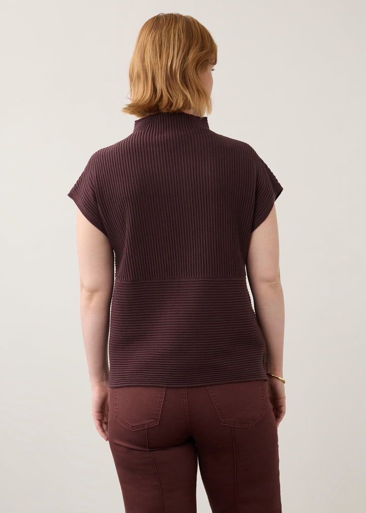 A woman viewed from the back wearing a dark burgundy ribbed short-sleeve mock neck top and matching burgundy pants against a light gray studio background.