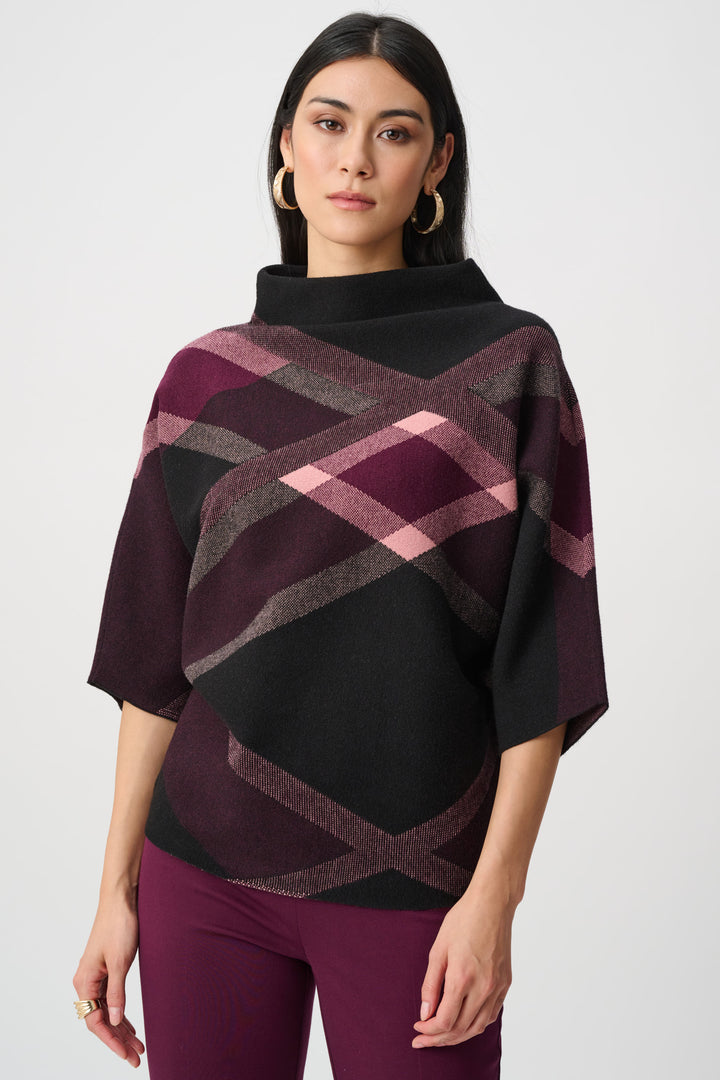 Woman wearing a plaid poncho with a plain background