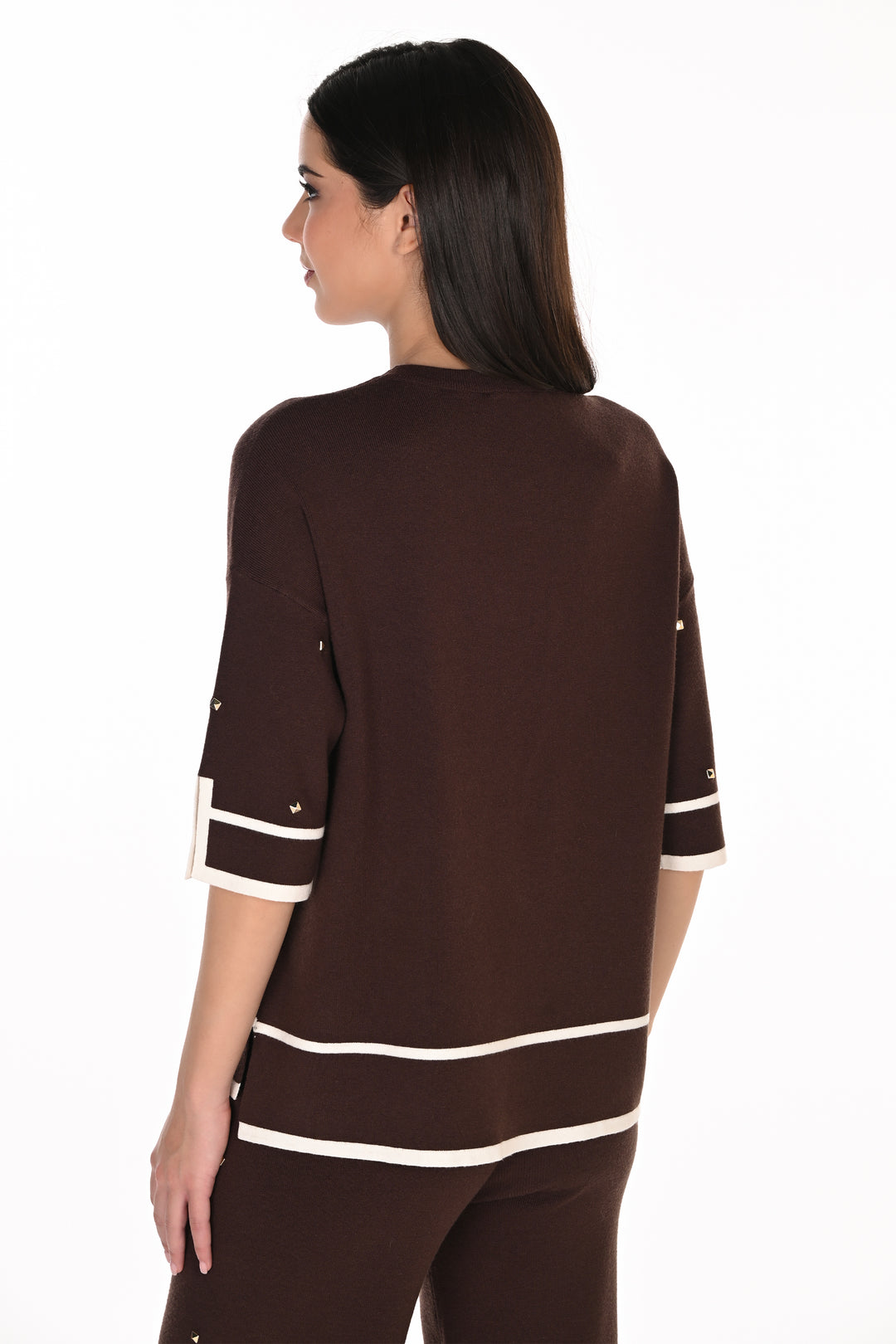 A woman shown from the back wearing a dark brown knit top with white stripe accents at the hem and sleeve cuffs, photographed against a plain white studio background.