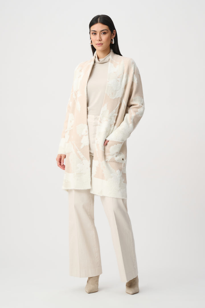 Woman wearing a beige outfit with a matching coat on a white background