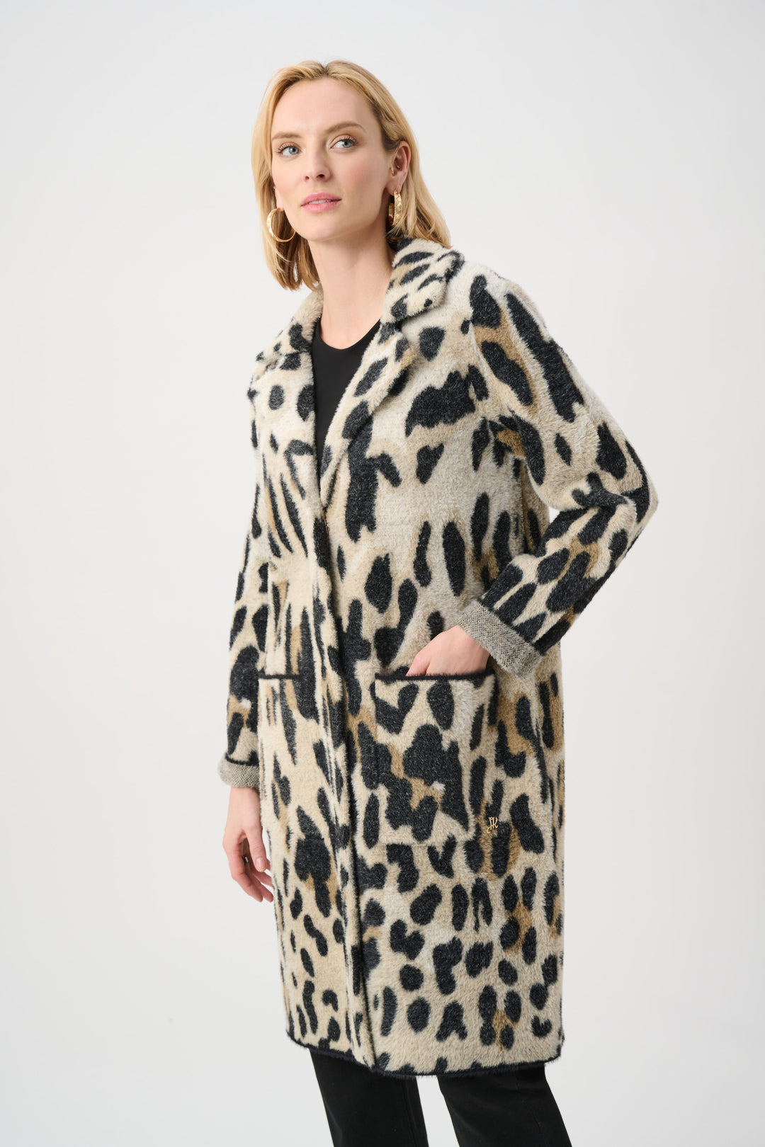 Woman wearing a leopard print coat on a white background