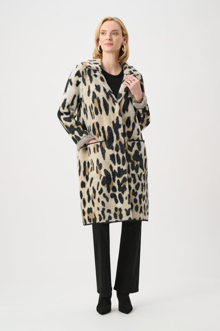 Woman wearing a leopard print coat on a white background