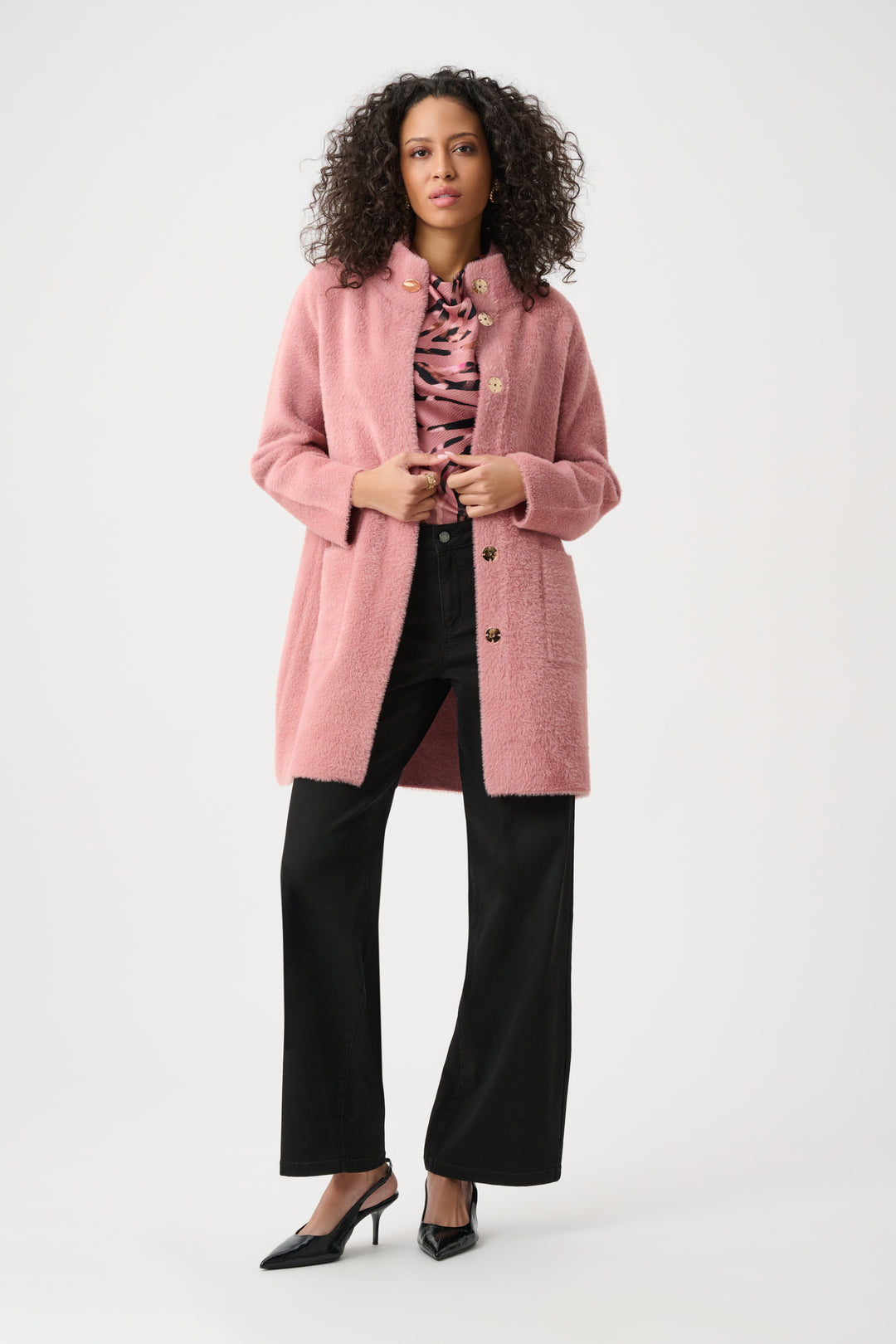 Woman wearing a pink coat on a white background