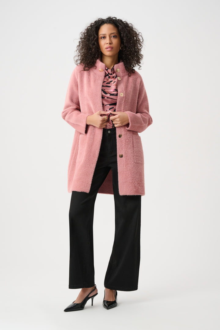 Woman wearing a pink coat on a white background