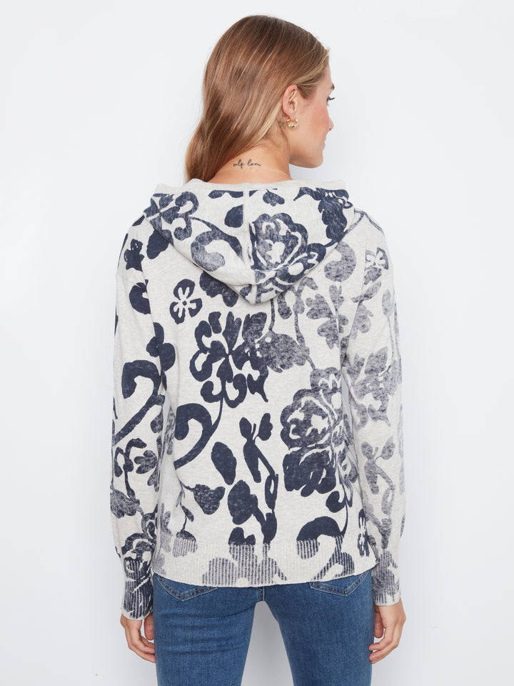 Woman wearing a floral-patterned sweater on a white background