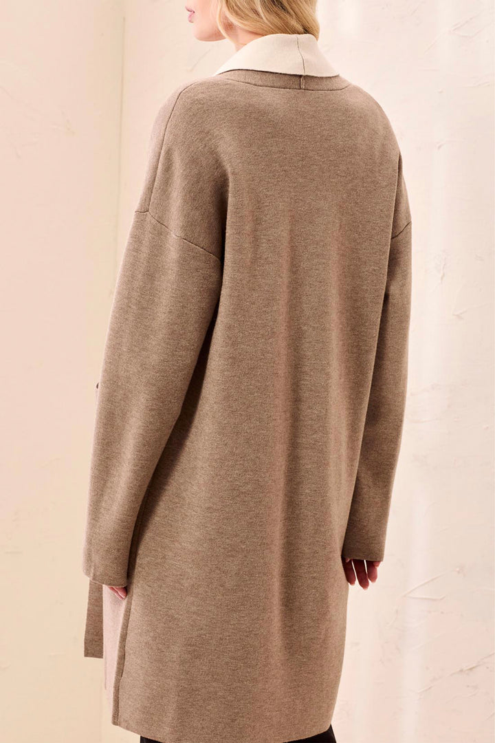 Brown coat worn by a person on a plain background