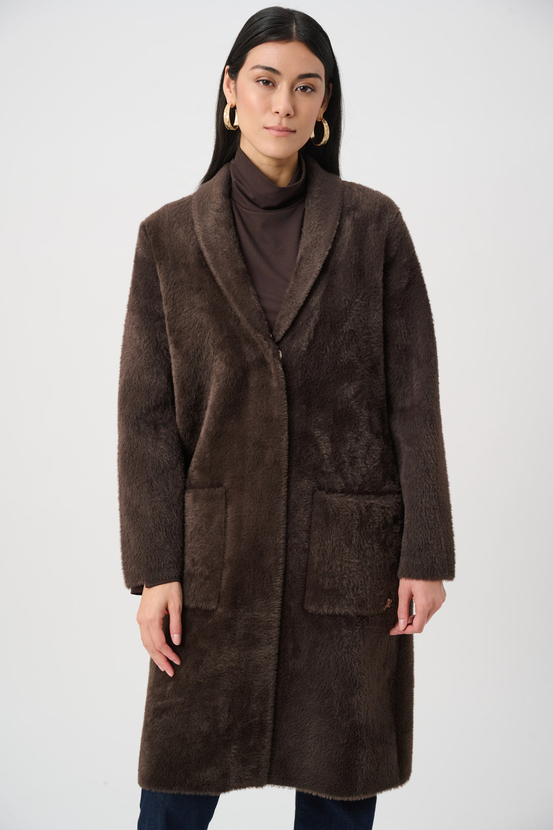 Woman wearing a brown coat on a white background