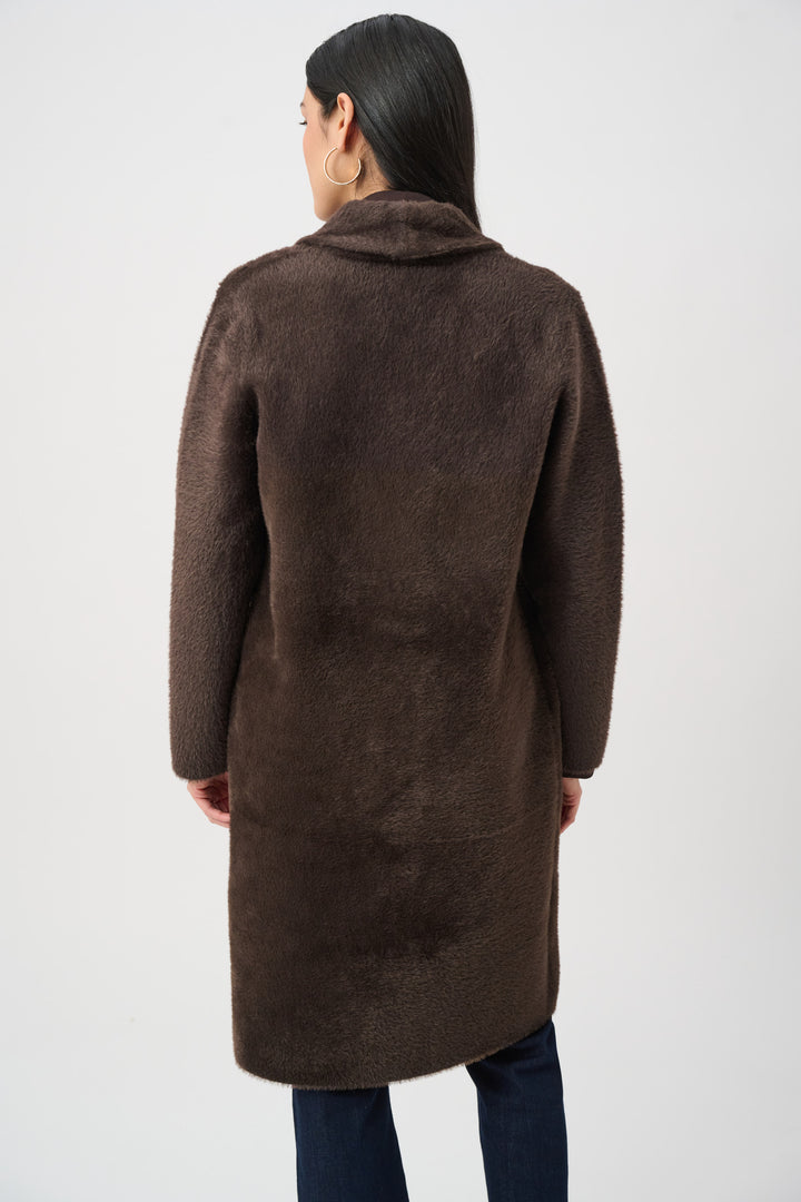 Person wearing a brown coat on a white background